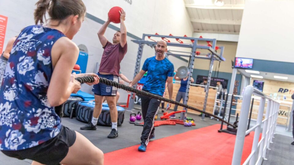 Members using the sled push in the functional zone at RP Fitness Cambridge