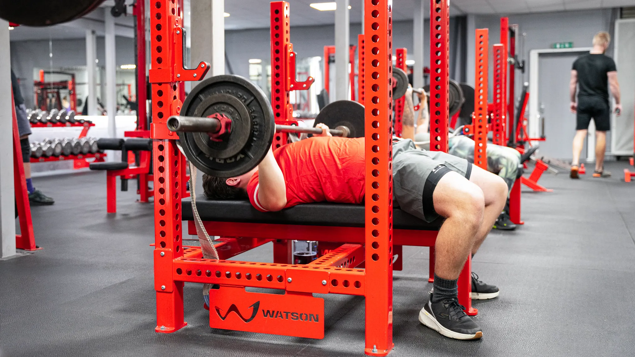 A member bench pressing on a Watson rack at RP Fitness Cambridge