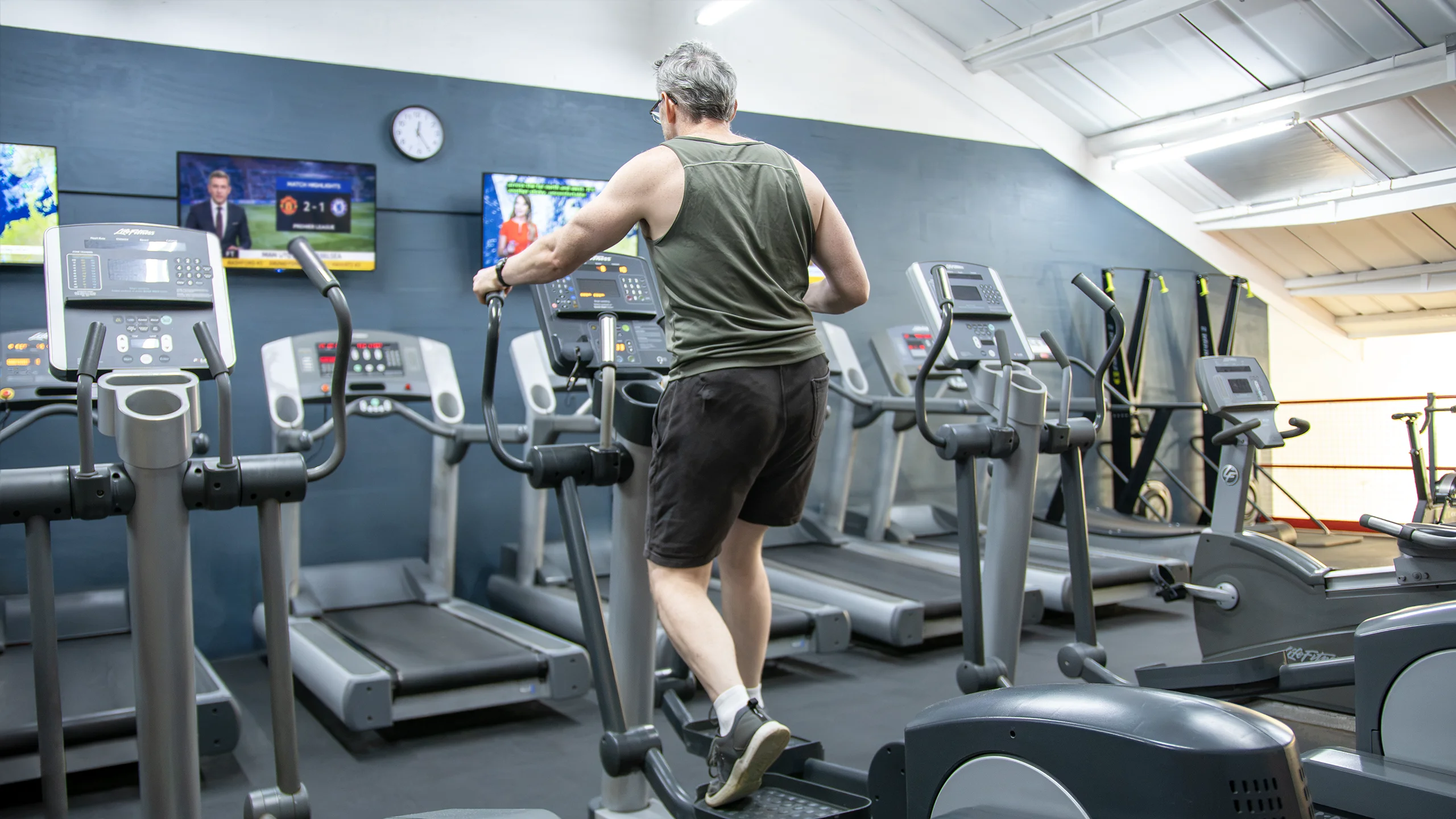 A member training on a cross-trainer in the cardio area at RP Fitness Cambridge
