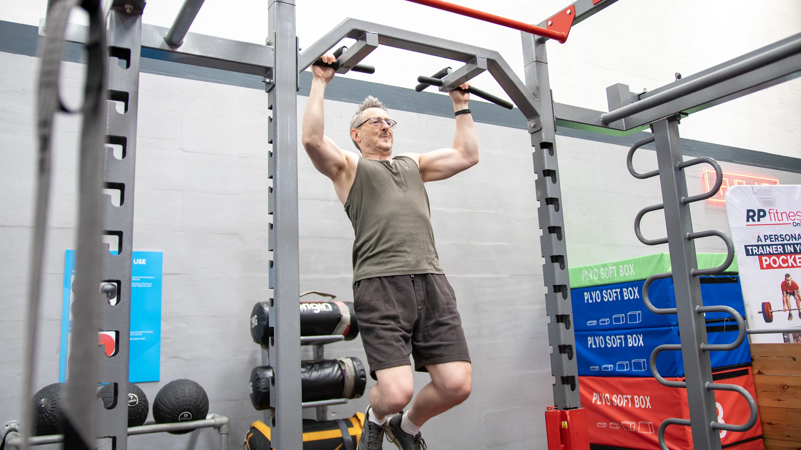 A member doing a pull-up on the functional training rig at RP Fitness Cambridge